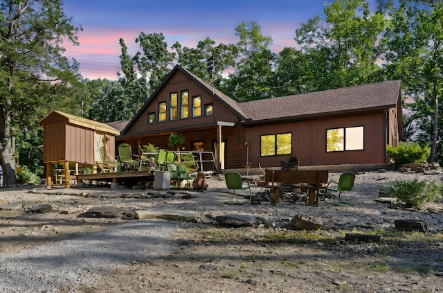 26474 Kings River Rd, Shell Knob, MO 65747 - back of property at dusk with a shingled roof