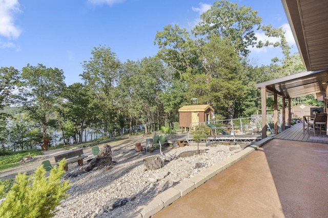26474 Kings River Rd, Shell Knob, MO 65747 - view of patio with a storage shed and view of wooded area