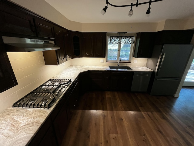 805 E 13th St, Cassville, MO 65625 - kitchen featuring under cabinet range hood, stainless steel appliances, dark wood-style flooring, and light countertops