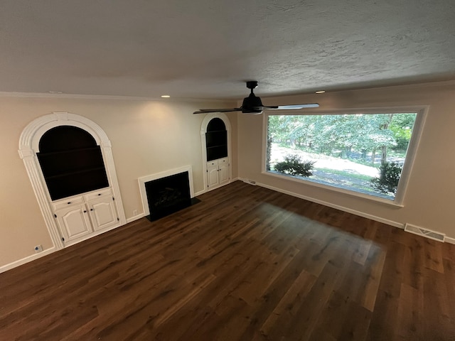 805 E 13th St, Cassville, MO 65625 - unfurnished living room featuring a fireplace with flush hearth, ceiling fan, dark wood-type flooring, crown molding, and recessed lighting