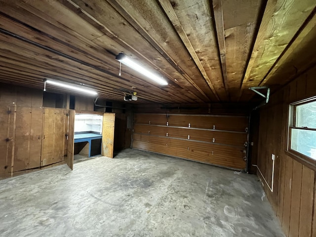 805 E 13th St, Cassville, MO 65625 - garage with wood walls and a garage door opener