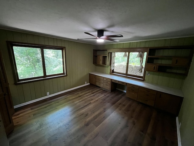 805 E 13th St, Cassville, MO 65625 - unfurnished office featuring built in study area, dark wood-style floors, a ceiling fan, and wooden walls
