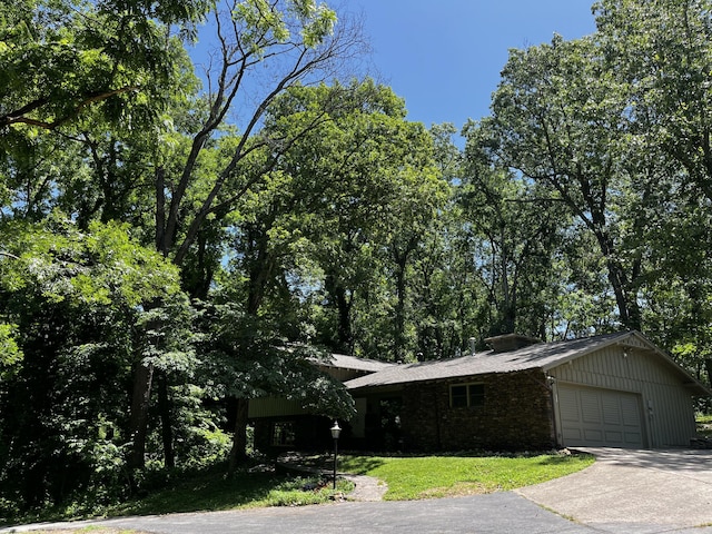 805 E 13th St, Cassville, MO 65625 - view of front facade featuring an attached garage, concrete driveway, and brick siding