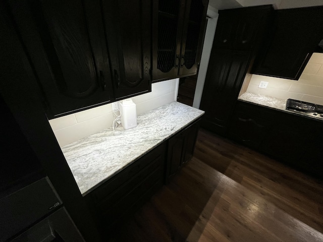 805 E 13th St, Cassville, MO 65625 - kitchen featuring dark cabinetry, dark wood-style floors, and light countertops