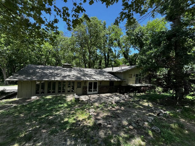 805 E 13th St, Cassville, MO 65625 - view of front of home with board and batten siding and french doors