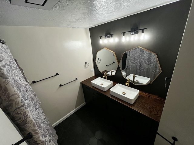 805 E 13th St, Cassville, MO 65625 - bathroom with double vanity and a textured ceiling