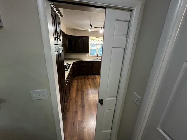 805 E 13th St, Cassville, MO 65625 - kitchen with wood finished floors, light countertops, dark brown cabinets, and black gas stovetop