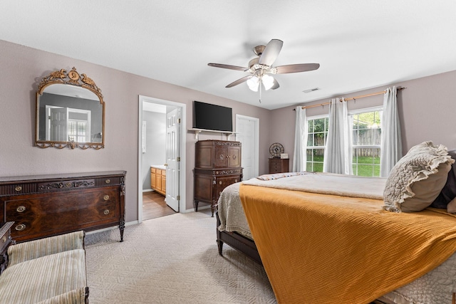 295 Deer Run Rd, Branson, MO 65616 - bedroom with light colored carpet, ensuite bathroom, and ceiling fan