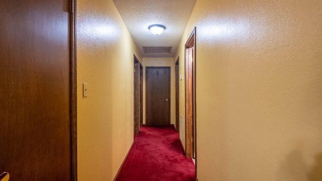 619 9th St, Thayer, MO 65791 - corridor featuring dark carpet and a textured ceiling