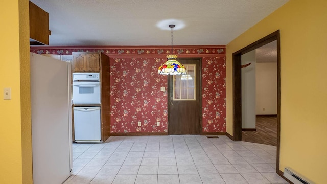 619 9th St, Thayer, MO 65791 - kitchen with white appliances, baseboard heating, decorative light fixtures, light tile patterned flooring, and a textured ceiling