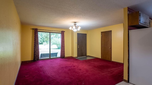 619 9th St, Thayer, MO 65791 - carpeted empty room with a chandelier and a textured ceiling