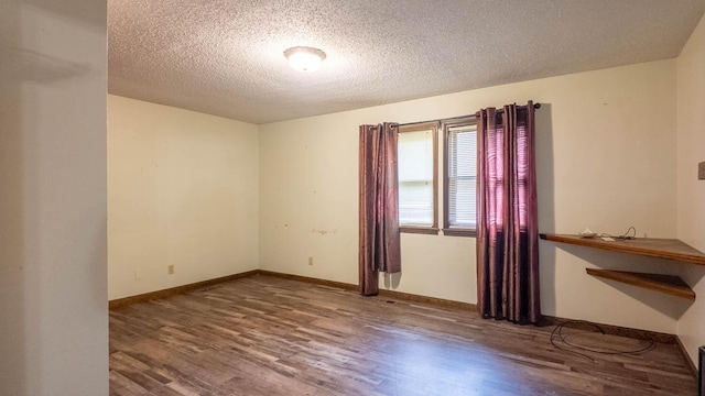 619 9th St, Thayer, MO 65791 - spare room featuring wood finished floors and a textured ceiling