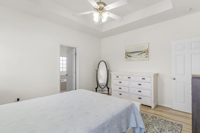 3790 W Rockwood St, Springfield, MO 65807 - bedroom with light wood-style flooring, a tray ceiling, ensuite bathroom, and ceiling fan