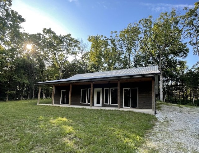 24136 Lazy Daze Ln, Wheatland, MO 65779 - rear view of house featuring a yard and a metal roof