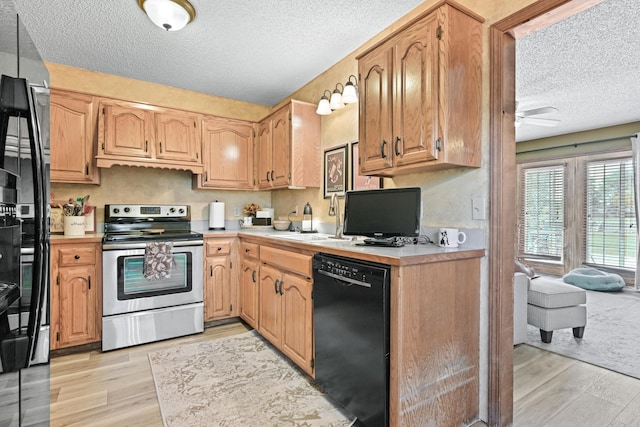 1617 Alexandra Dr, Carthage, MO 64836 - kitchen with stainless steel electric range, dishwasher, a textured ceiling, light wood-type flooring, and light countertops