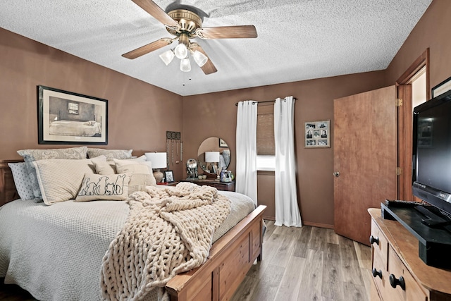 1617 Alexandra Dr, Carthage, MO 64836 - bedroom with light wood-type flooring, a textured ceiling, and a ceiling fan