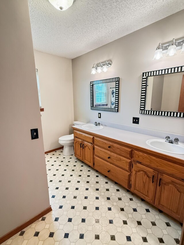 1617 Alexandra Dr, Carthage, MO 64836 - full bathroom featuring double vanity and a textured ceiling