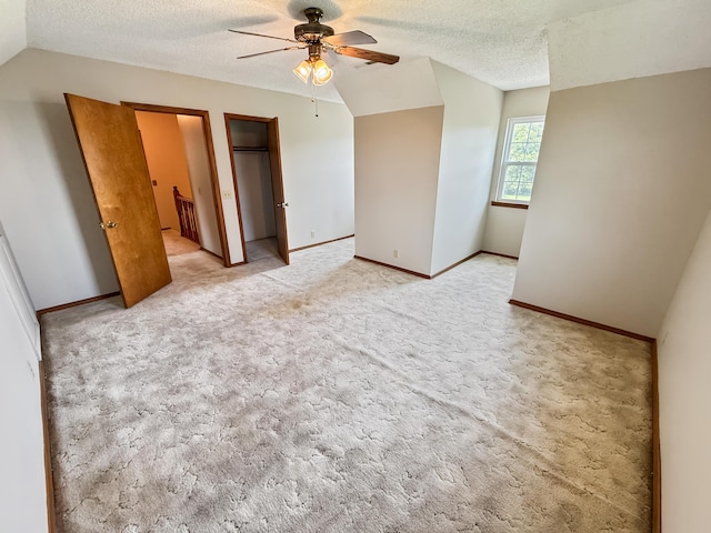 1617 Alexandra Dr, Carthage, MO 64836 - unfurnished bedroom featuring lofted ceiling, a textured ceiling, light carpet, and ceiling fan