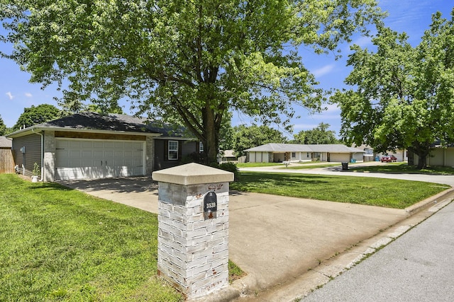 3539 S Walnut Hill Dr, Springfield, MO 65807 - ranch-style home with a front lawn, a garage, brick siding, and driveway