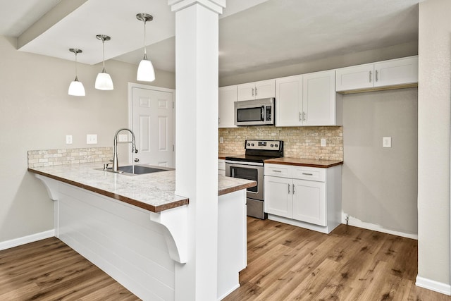 3539 S Walnut Hill Dr, Springfield, MO 65807 - kitchen with appliances with stainless steel finishes, tasteful backsplash, wood finished floors, and white cabinets