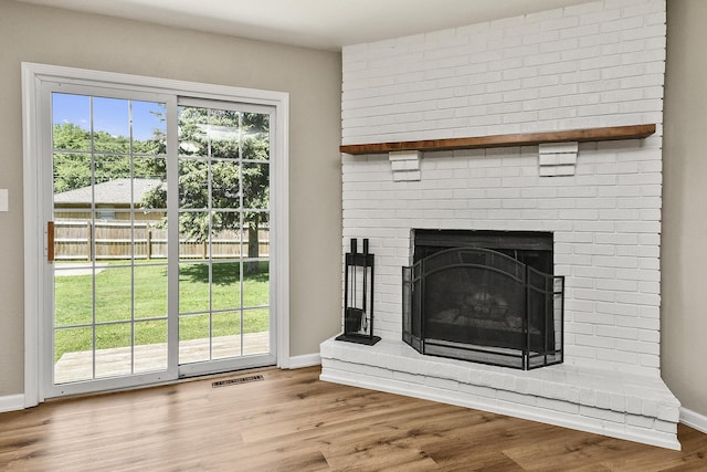 3539 S Walnut Hill Dr, Springfield, MO 65807 - detailed view of a brick fireplace and wood finished floors