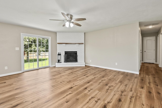 3539 S Walnut Hill Dr, Springfield, MO 65807 - unfurnished living room featuring a ceiling fan, wood finished floors, and a brick fireplace