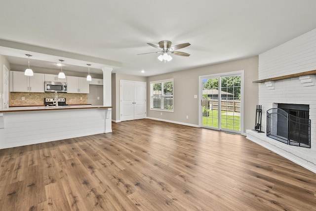 3539 S Walnut Hill Dr, Springfield, MO 65807 - unfurnished living room with a ceiling fan, dark wood-type flooring, and a fireplace