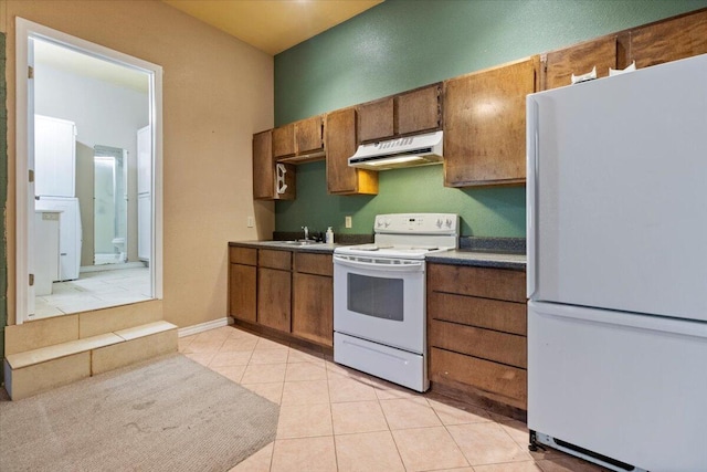 3493 US Highway 160, West Plains, MO 65775 - kitchen featuring white appliances, under cabinet range hood, brown cabinets, and light tile patterned floors