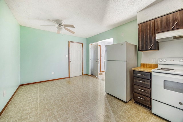 1016 S Lexington Ave, Springfield, MO 65802 - kitchen featuring white appliances, under cabinet range hood, dark brown cabinets, ceiling fan, and light countertops