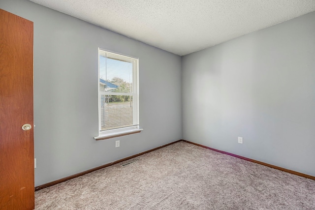 1016 S Lexington Ave, Springfield, MO 65802 - empty room featuring carpet flooring and a textured ceiling
