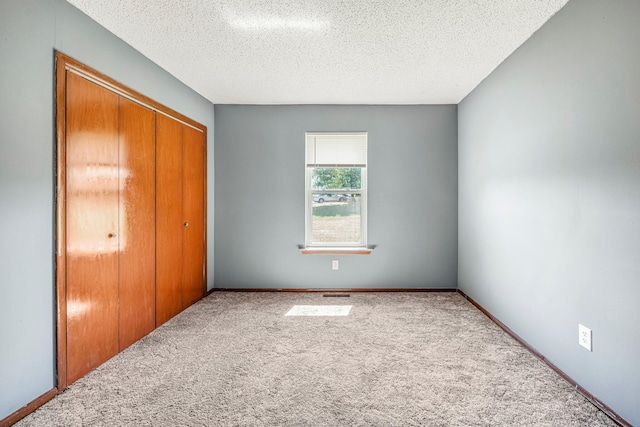 1016 S Lexington Ave, Springfield, MO 65802 - unfurnished bedroom with a closet, carpet floors, and a textured ceiling