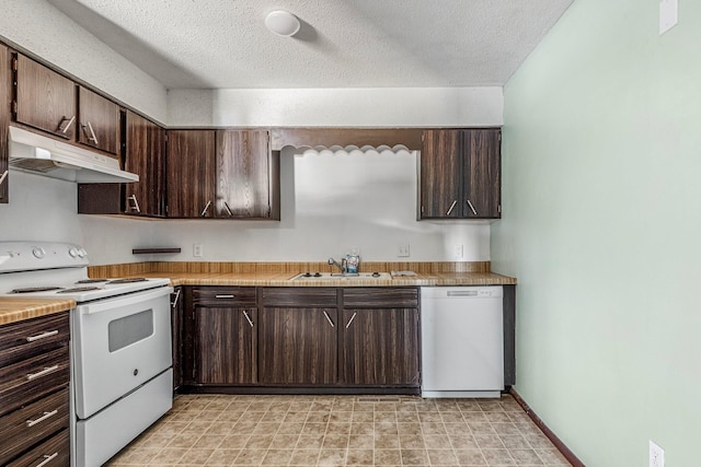 1016 S Lexington Ave, Springfield, MO 65802 - kitchen with white appliances, under cabinet range hood, dark brown cabinetry, light countertops, and a textured ceiling