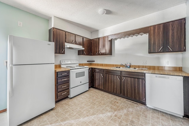 1016 S Lexington Ave, Springfield, MO 65802 - kitchen featuring white appliances, dark brown cabinetry, light countertops, and a textured ceiling