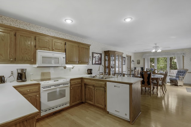 3416 S Barnes Ave, Springfield, MO 65804 - kitchen with white appliances, wallpapered walls, a peninsula, light wood-style floors, and light countertops