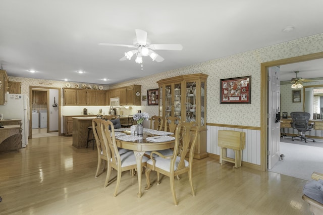 3416 S Barnes Ave, Springfield, MO 65804 - dining space featuring wallpapered walls, a ceiling fan, light wood finished floors, a desk, and washer / clothes dryer