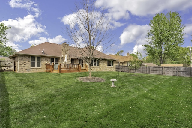3416 S Barnes Ave, Springfield, MO 65804 - back of property with a fenced backyard, a wooden deck, a chimney, and brick siding