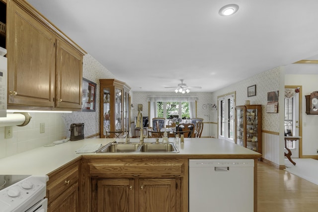 3416 S Barnes Ave, Springfield, MO 65804 - kitchen with white appliances, wallpapered walls, a peninsula, light wood-style flooring, and light countertops
