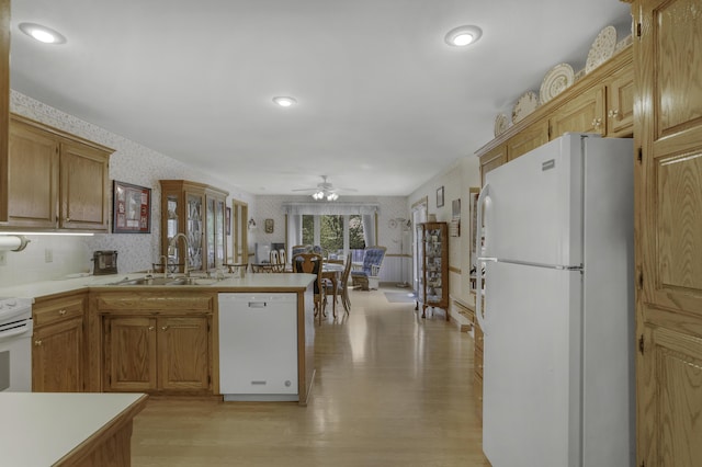 3416 S Barnes Ave, Springfield, MO 65804 - kitchen featuring white appliances, wallpapered walls, a peninsula, a ceiling fan, and light countertops