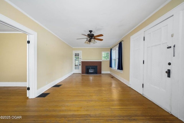802 Hampton Pl, Joplin, MO 64801 - unfurnished living room with a ceiling fan, a brick fireplace, ornamental molding, and wood finished floors