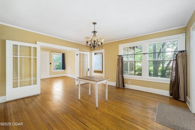 802 Hampton Pl, Joplin, MO 64801 - unfurnished dining area featuring a chandelier, ornamental molding, and hardwood / wood-style floors