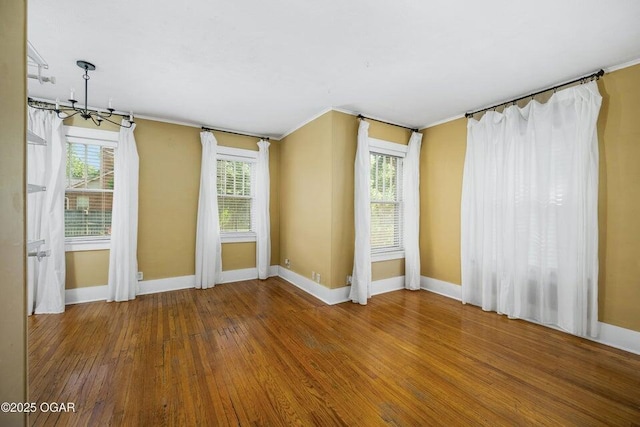 802 Hampton Pl, Joplin, MO 64801 - spare room featuring a chandelier, wood-type flooring, and crown molding