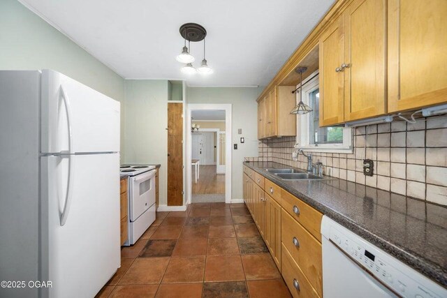 802 Hampton Pl, Joplin, MO 64801 - kitchen featuring white appliances, backsplash, dark countertops, and hanging light fixtures