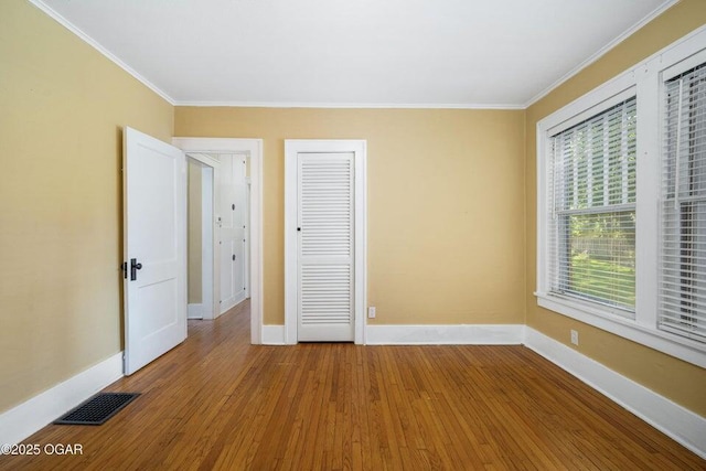 802 Hampton Pl, Joplin, MO 64801 - unfurnished bedroom with ornamental molding, wood-type flooring, and a closet
