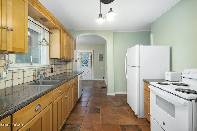 802 Hampton Pl, Joplin, MO 64801 - kitchen featuring white appliances, arched walkways, dark countertops, tasteful backsplash, and ornamental molding