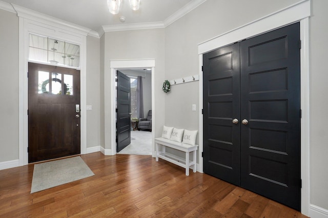 914 W Lorenza Dr, Nixa, MO 65714 - entrance foyer with crown molding, wood finished floors, and a chandelier