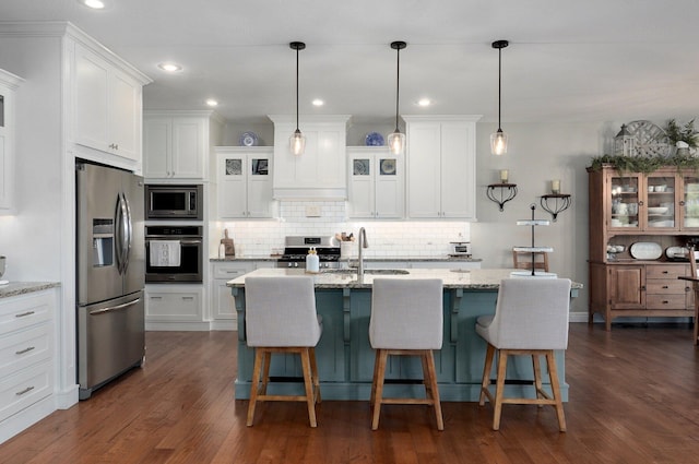 914 W Lorenza Dr, Nixa, MO 65714 - kitchen with appliances with stainless steel finishes, backsplash, white cabinetry, dark wood-style flooring, and recessed lighting