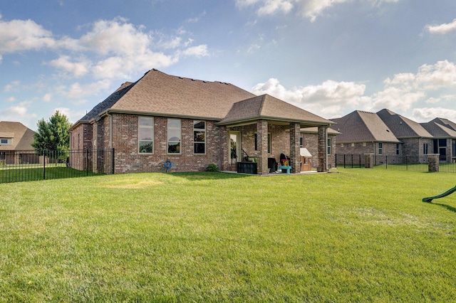 914 W Lorenza Dr, Nixa, MO 65714 - back of property featuring brick siding, a fenced backyard, and roof with shingles