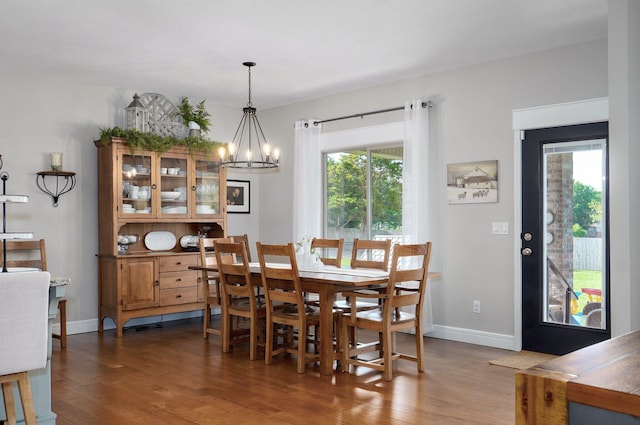 914 W Lorenza Dr, Nixa, MO 65714 - dining space with wood finished floors, a chandelier, and healthy amount of natural light