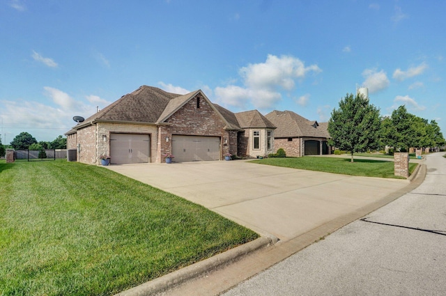 914 W Lorenza Dr, Nixa, MO 65714 - view of front facade featuring a garage, brick siding, driveway, and a shingled roof