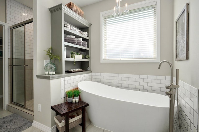 914 W Lorenza Dr, Nixa, MO 65714 - bathroom with healthy amount of natural light, a shower stall, a freestanding bath, and tile walls